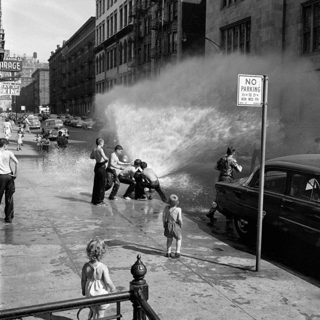 Kids playing in a fire hydrant in NYC in the summer of 1954